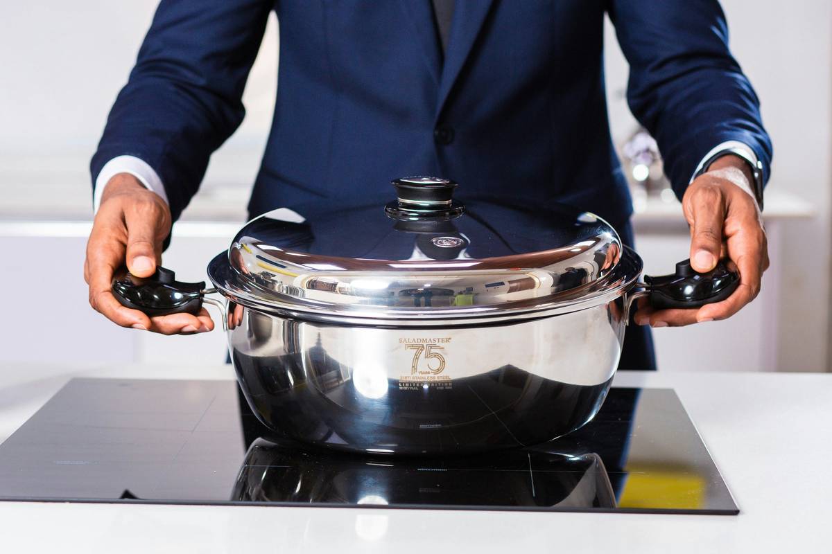 pressure cooker model how to install: close-up of correctly seated gasket and aligned lid on a stainless steel pressure cooker